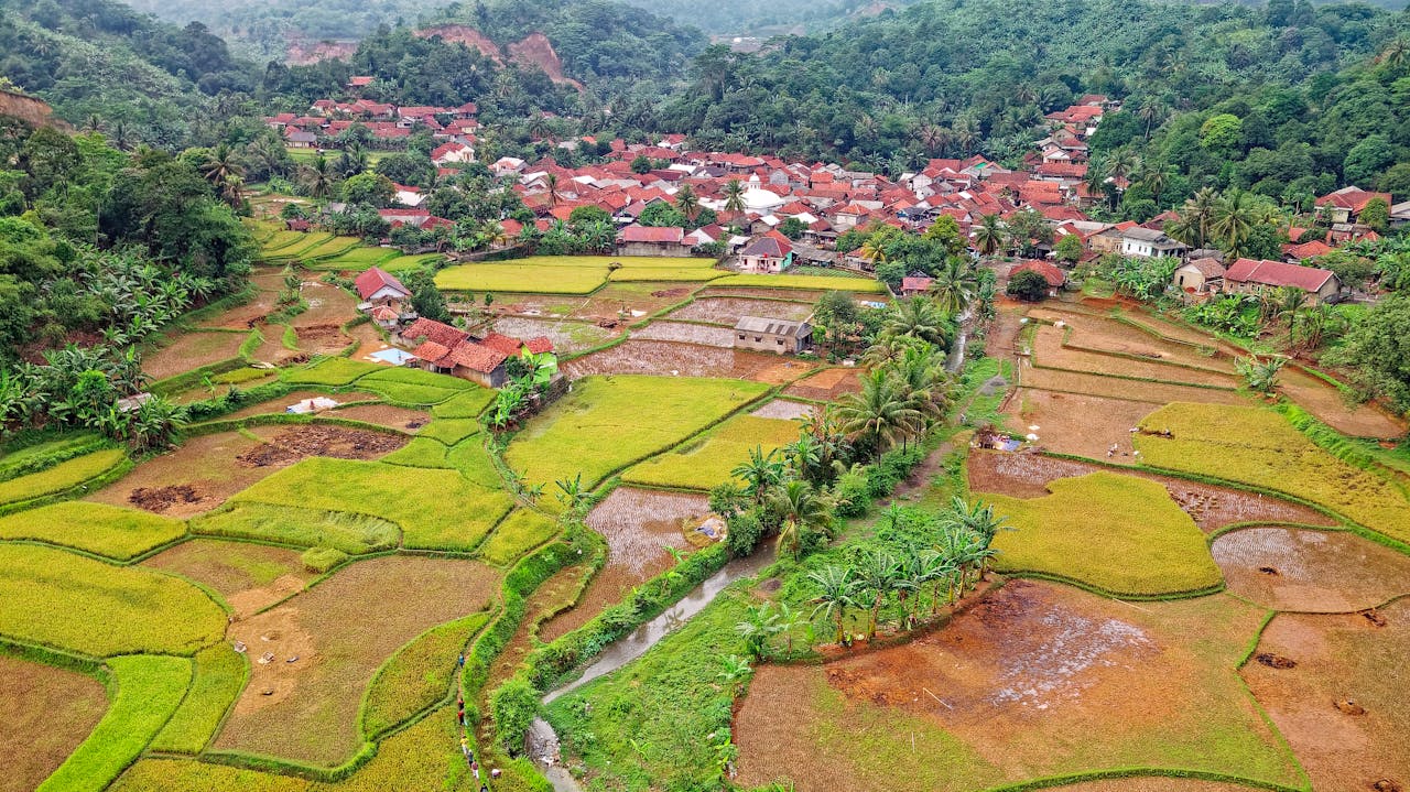 Mastering the First Impression: Your intriguing post title goes here Aerial view of Rumpin's lush rice terraces and traditional village in Indonesia.