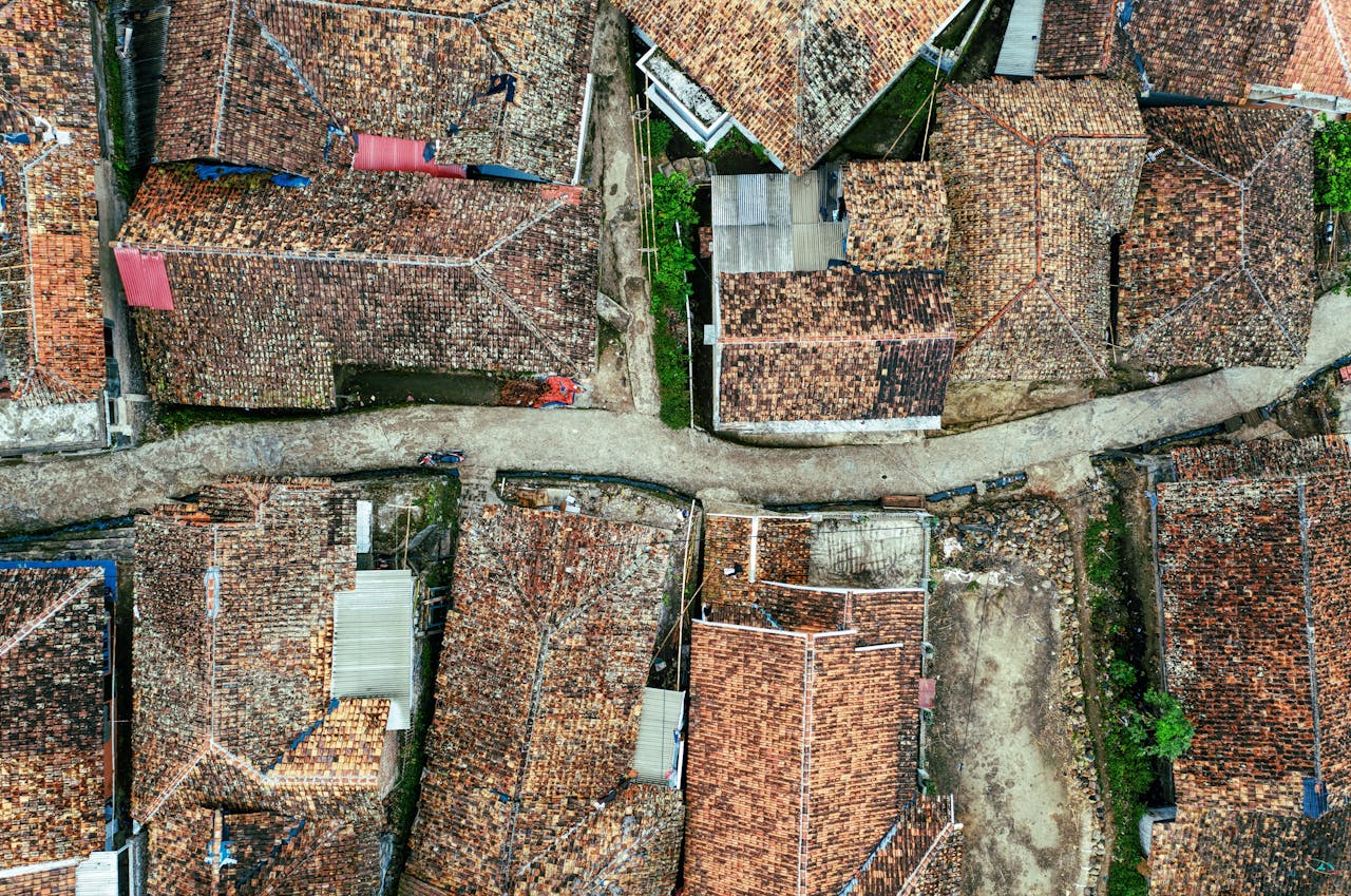 The Art of Drawing Readers In: Your attractive post title goes here Breathtaking aerial view of wild narrow river flowing among old typical residential houses with red tiled roofs in countryside